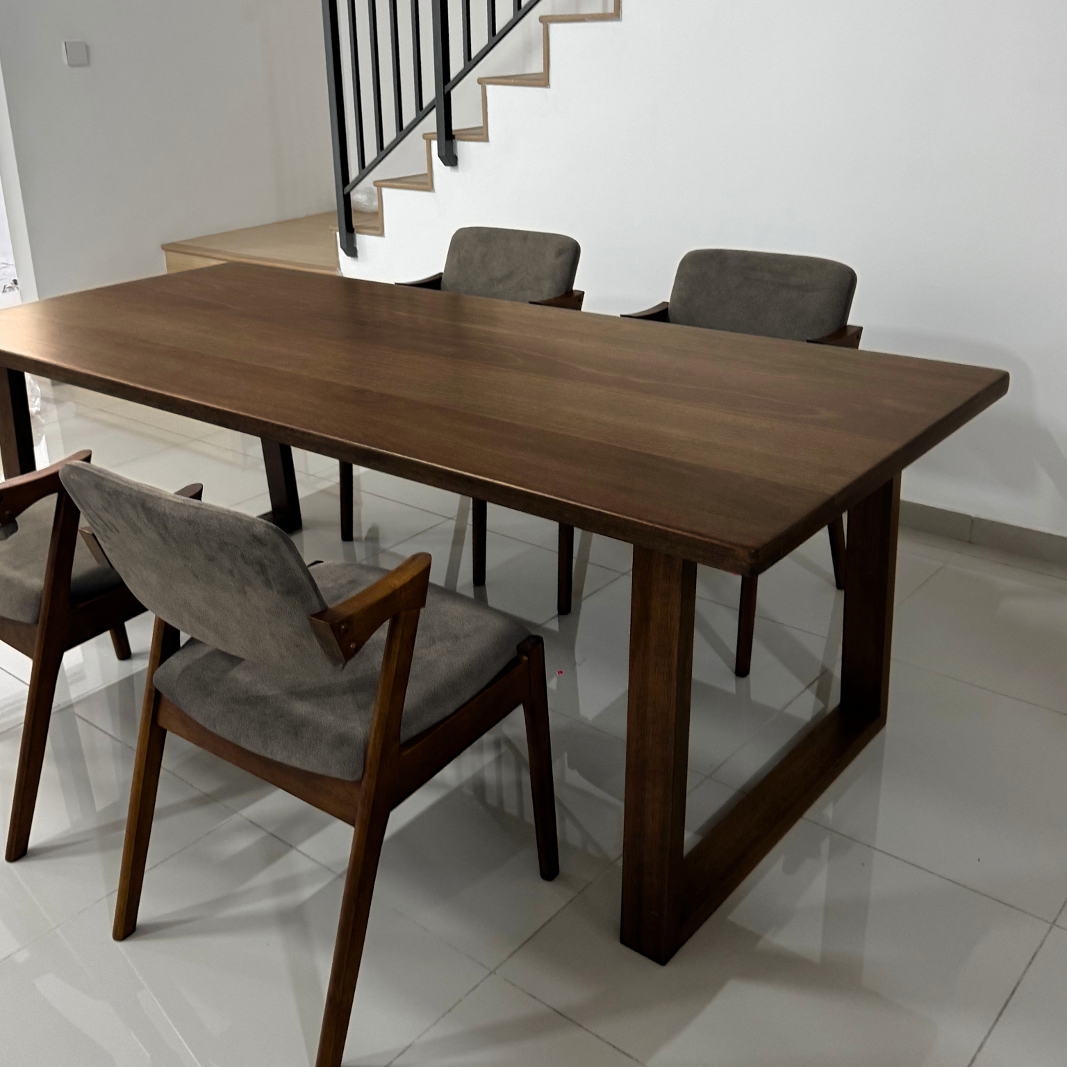 Solid Wood dining table with chairs in a room with a staircase