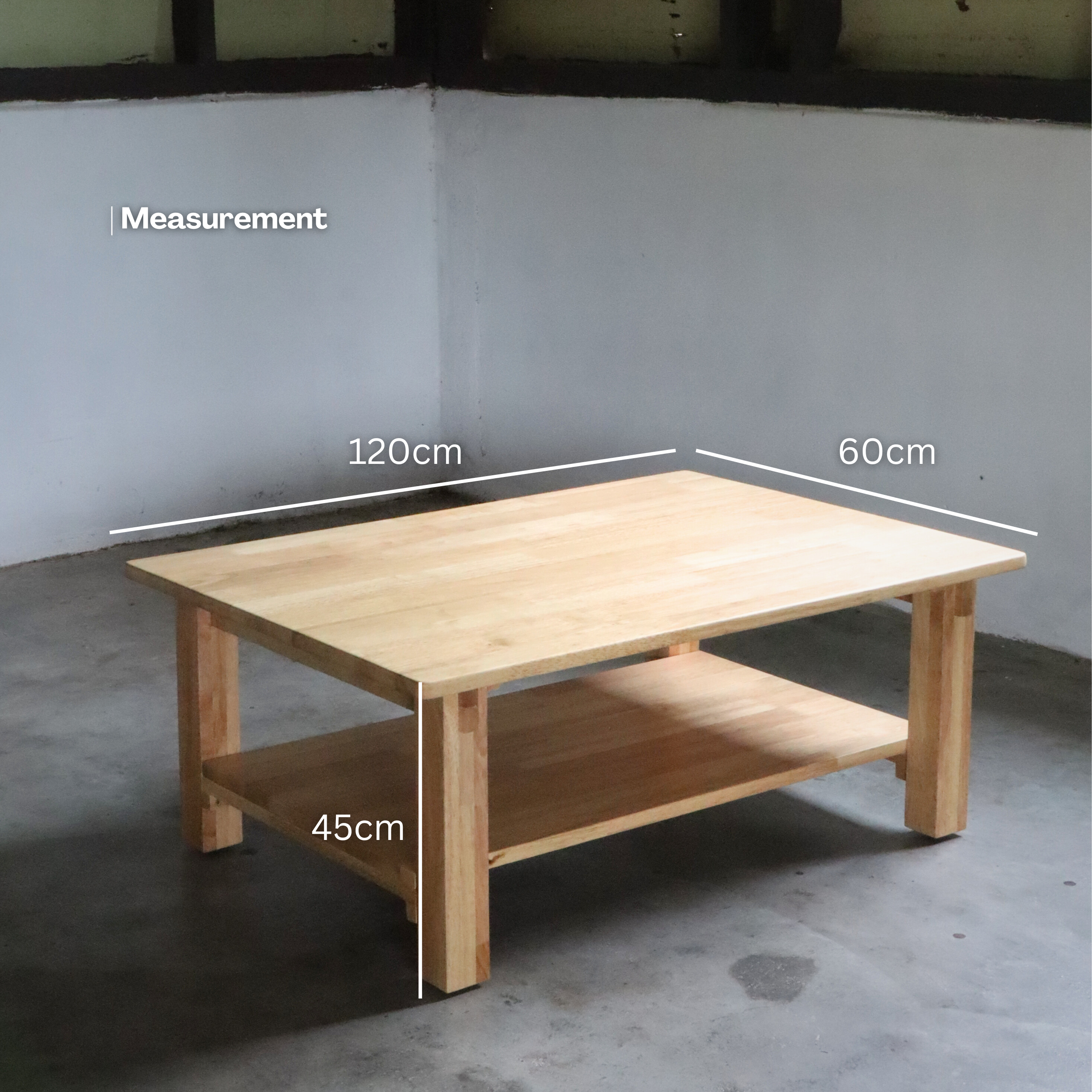 Wooden coffee table with shelf on a plain wall background