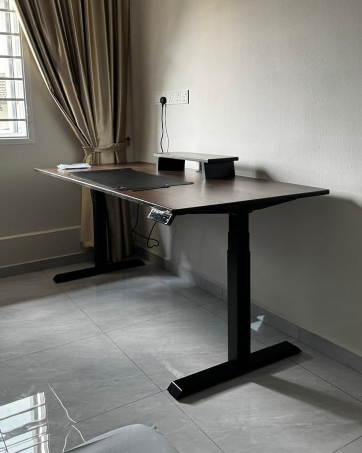 Wooden standing desk in a room with a window and curtain